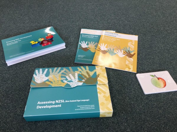 A set of the Assesing NZSL Development cards is displayed on a carpeted floor