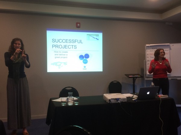 A person presenting a Successful Projects slide with an interpreter on the left